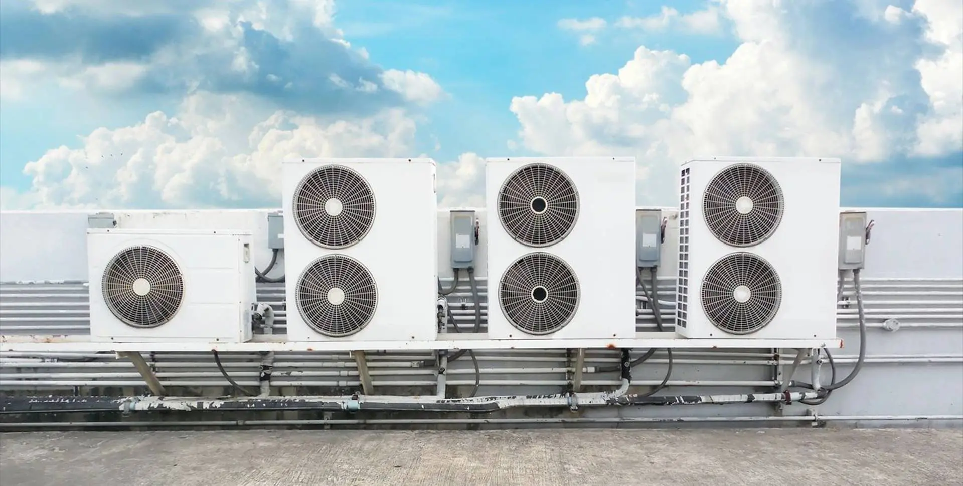 Compressor of Air Condition on Roof With Cloudy Sky Background
